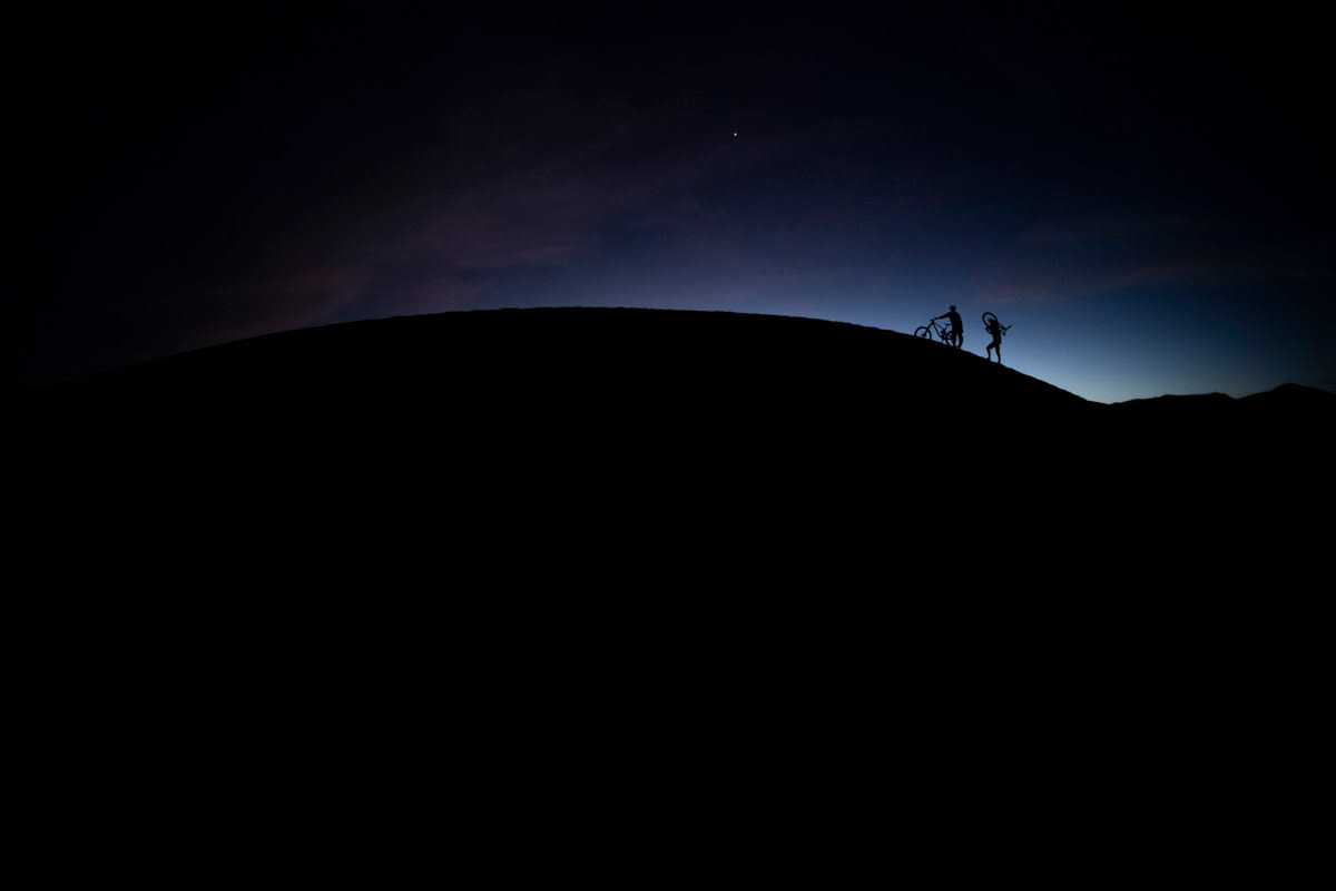 Riding dunes at night Mountain bike full suspension on sand