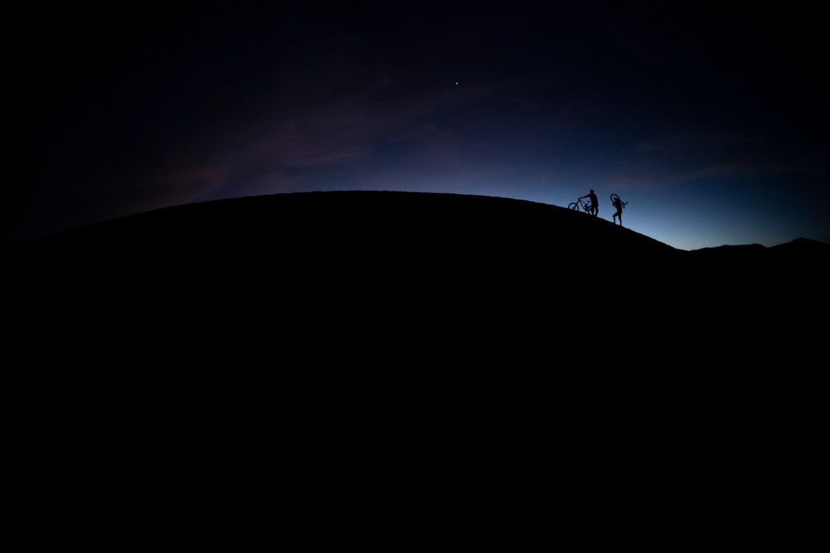 Riding dunes at night Mountain bike full suspension on sand