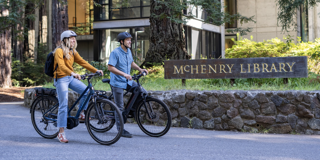 Image of male and female college students on ebikes