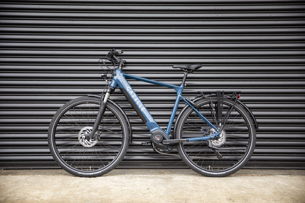 Blue Mid Drive Motor Ebike in front of black background