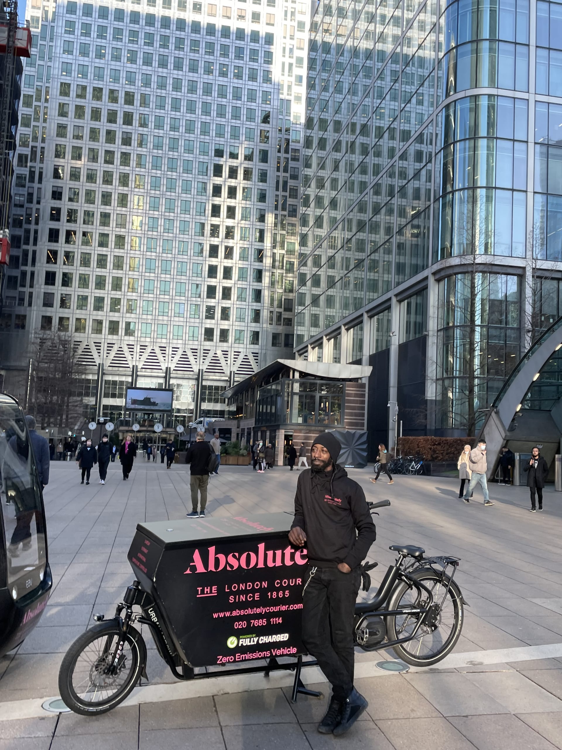 Absolutely Couriers rider standing at his Urban Arrow cargo bike at Canary Warf in London.